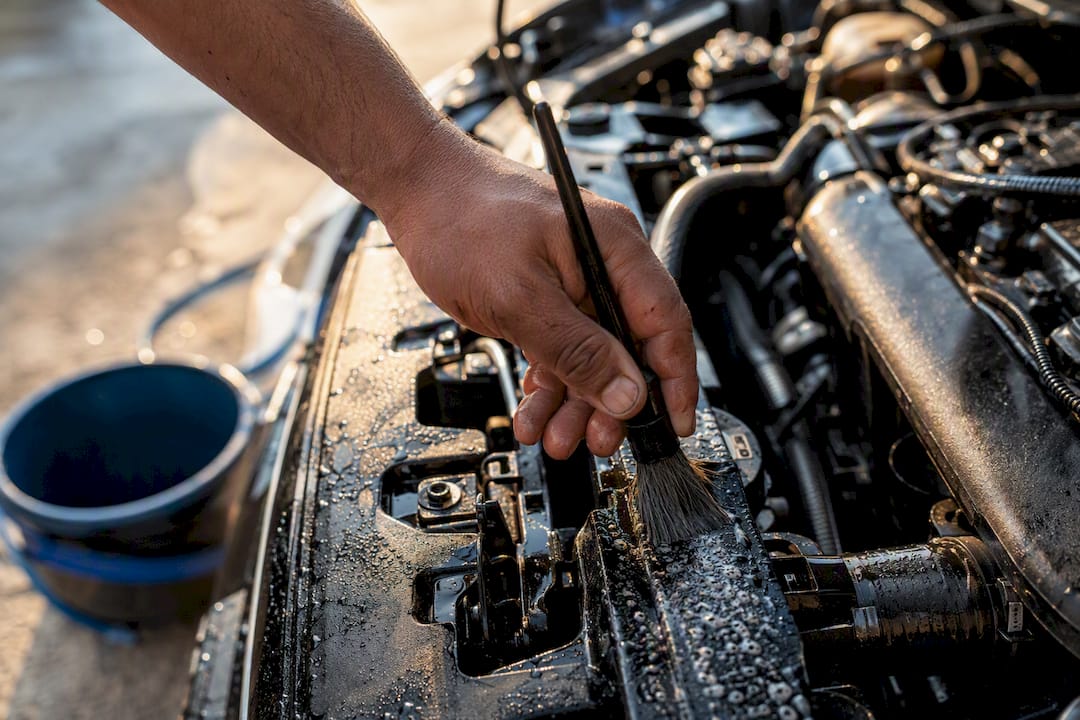 Detailer's hand scrubbing engine area