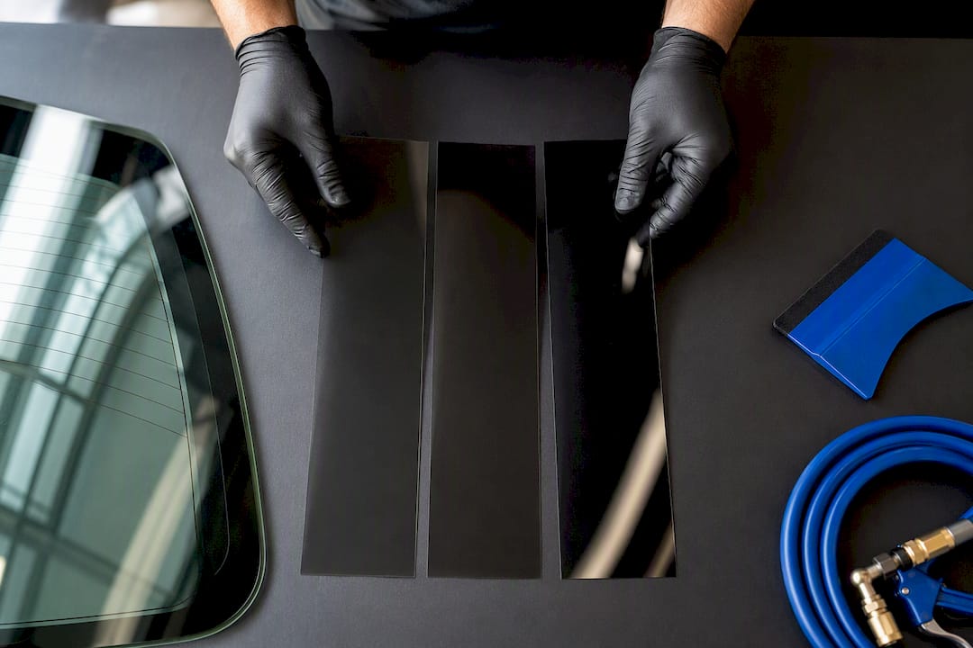 Installer comparing window film samples